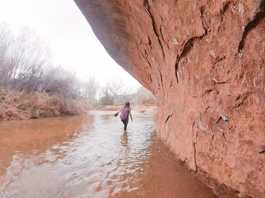 Wading through the water with our shoes in hand