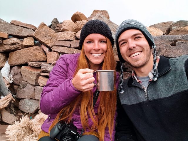 Enjoying a warm cup of coca tea at the top of the mountain