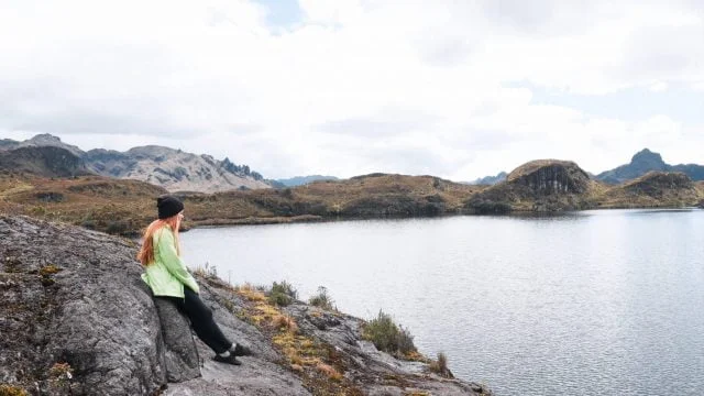 Lia sitting on a rock taking in the views of Laguna Toreadora