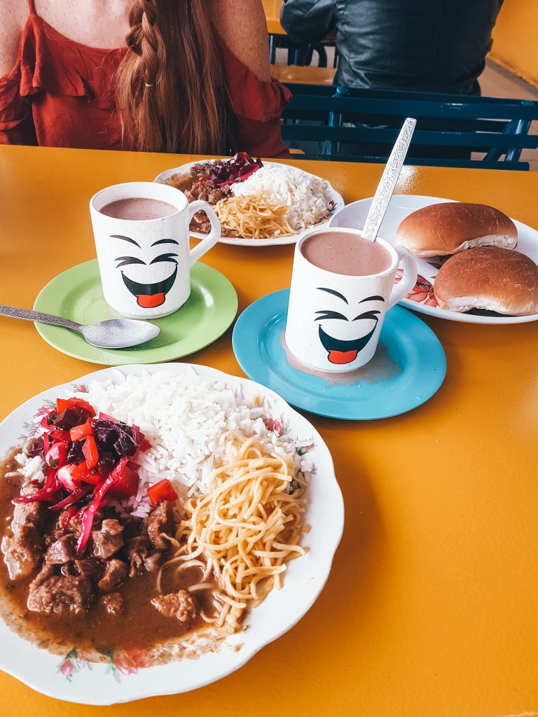 A unique breakfast of pasta, rice, stewed beef, beats, hot cocoa, and bread