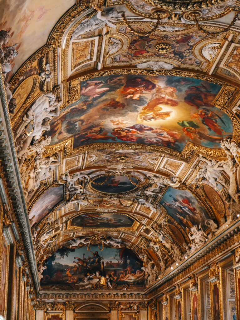 The intricate ceiling of one of the rooms in the Louvre