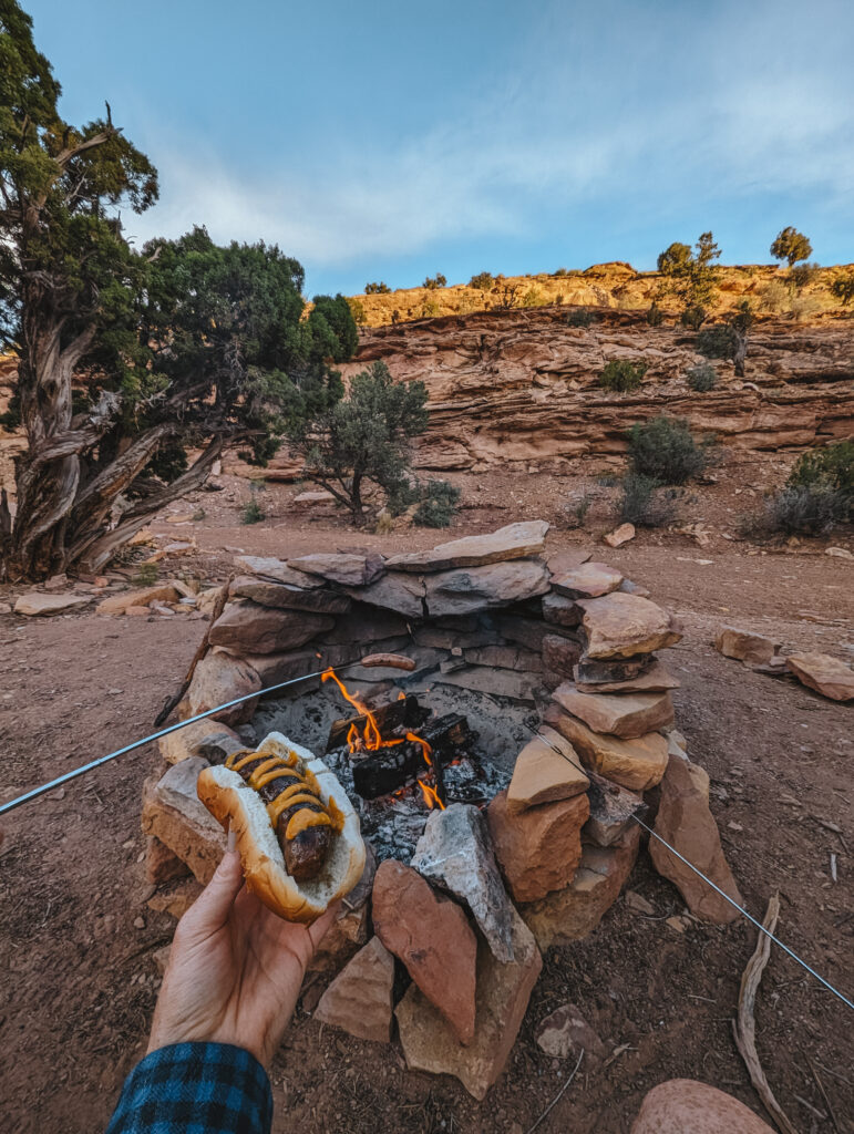 Roasting brats over the campfire