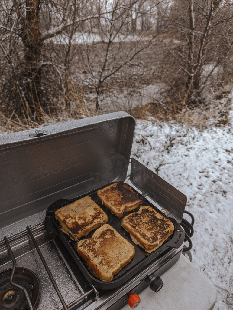 Cooking French toast on the cast iron griddle - camp kitchen