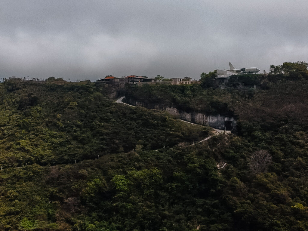 The road leading down to the beach. See the old airplane perched on the cliff?