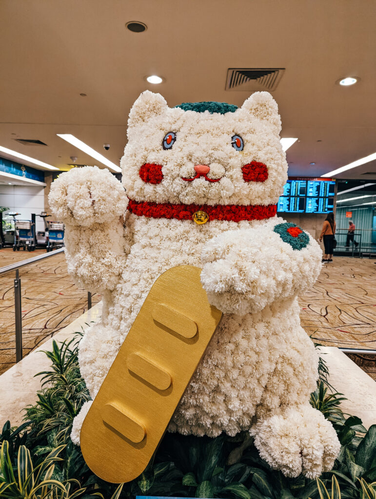 A cat figure made of flowers in the airport