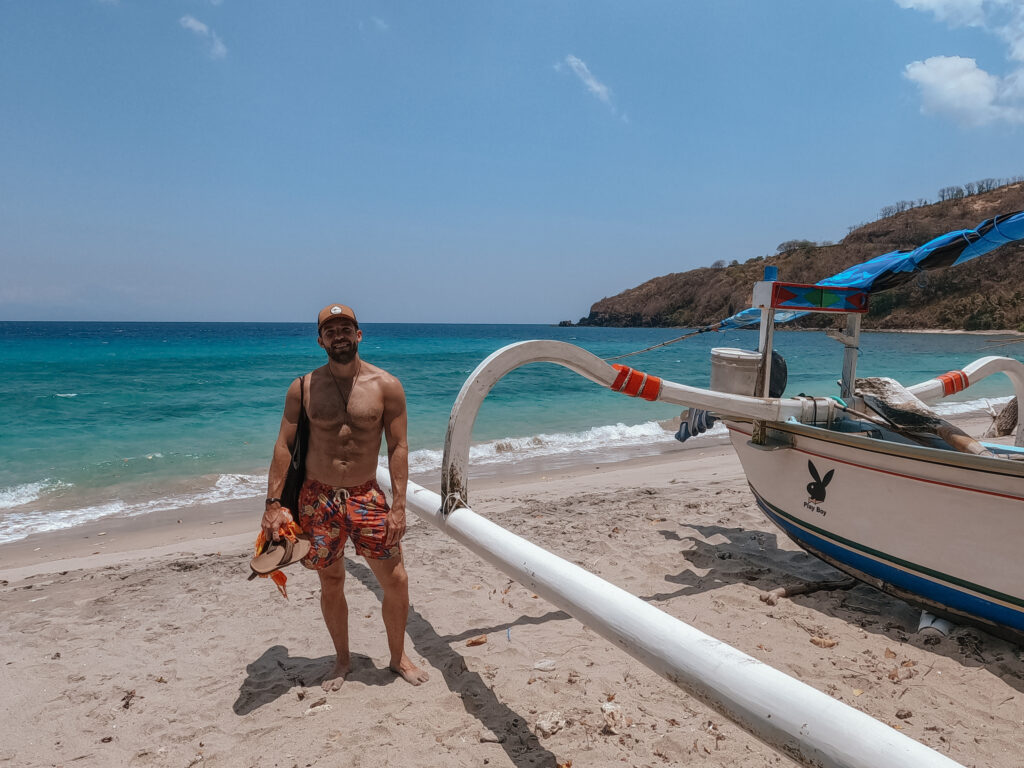 Matt near a boat at Nipah Beach