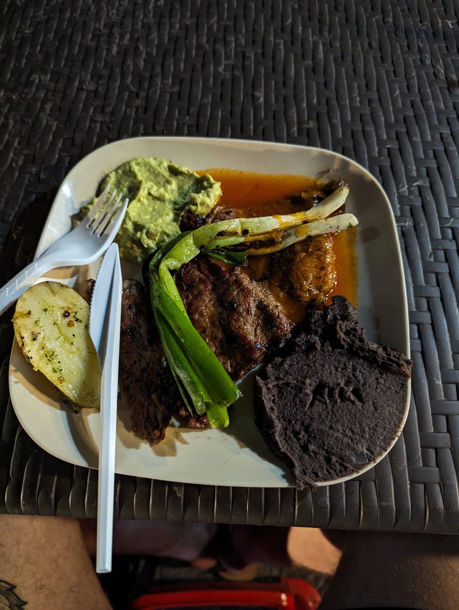 Beans, grilled meat, potato, and guacamole from Churrasquitos el buen Gusto
