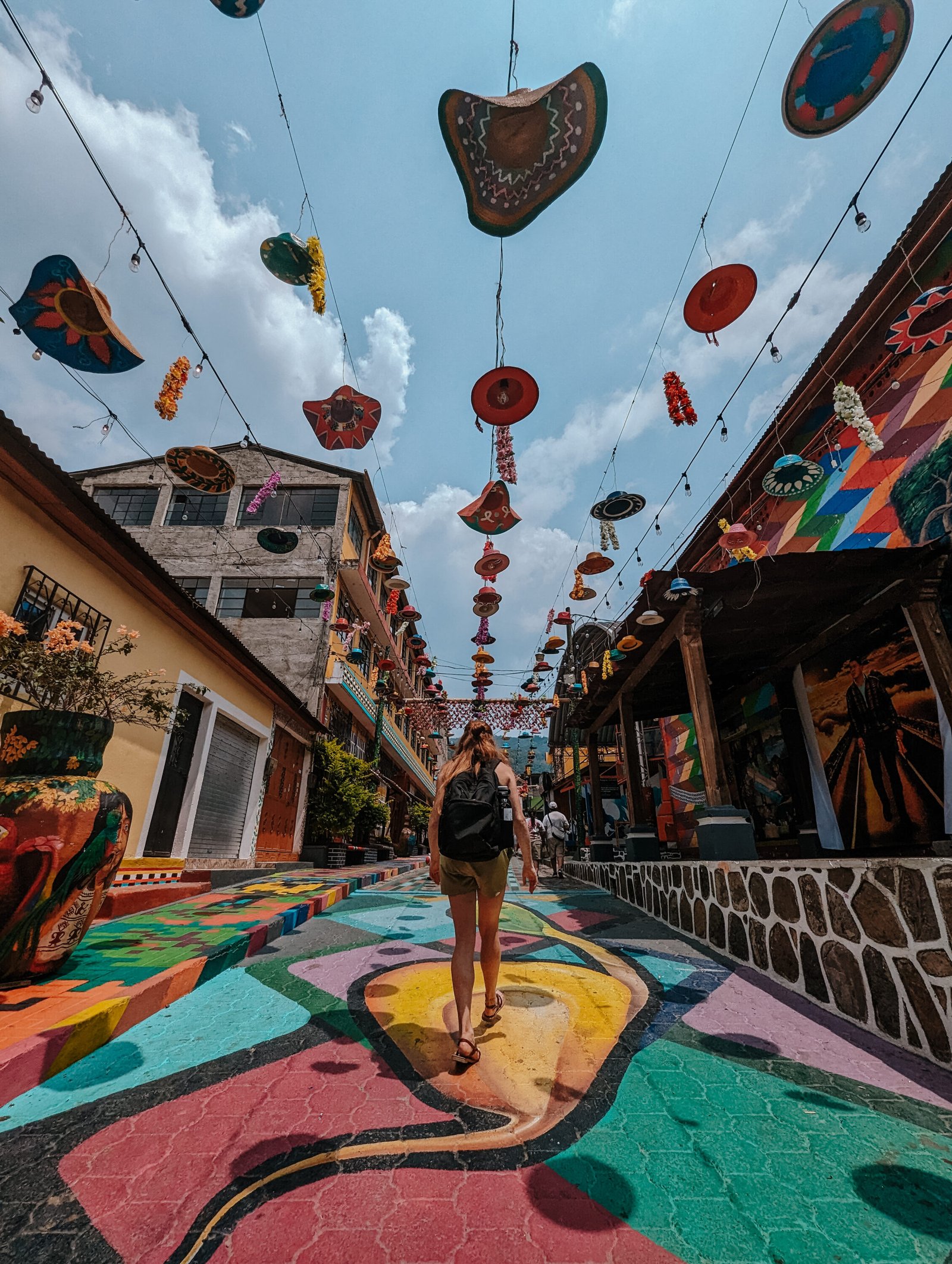 Lia walking down one of the colorful streets of San Juan