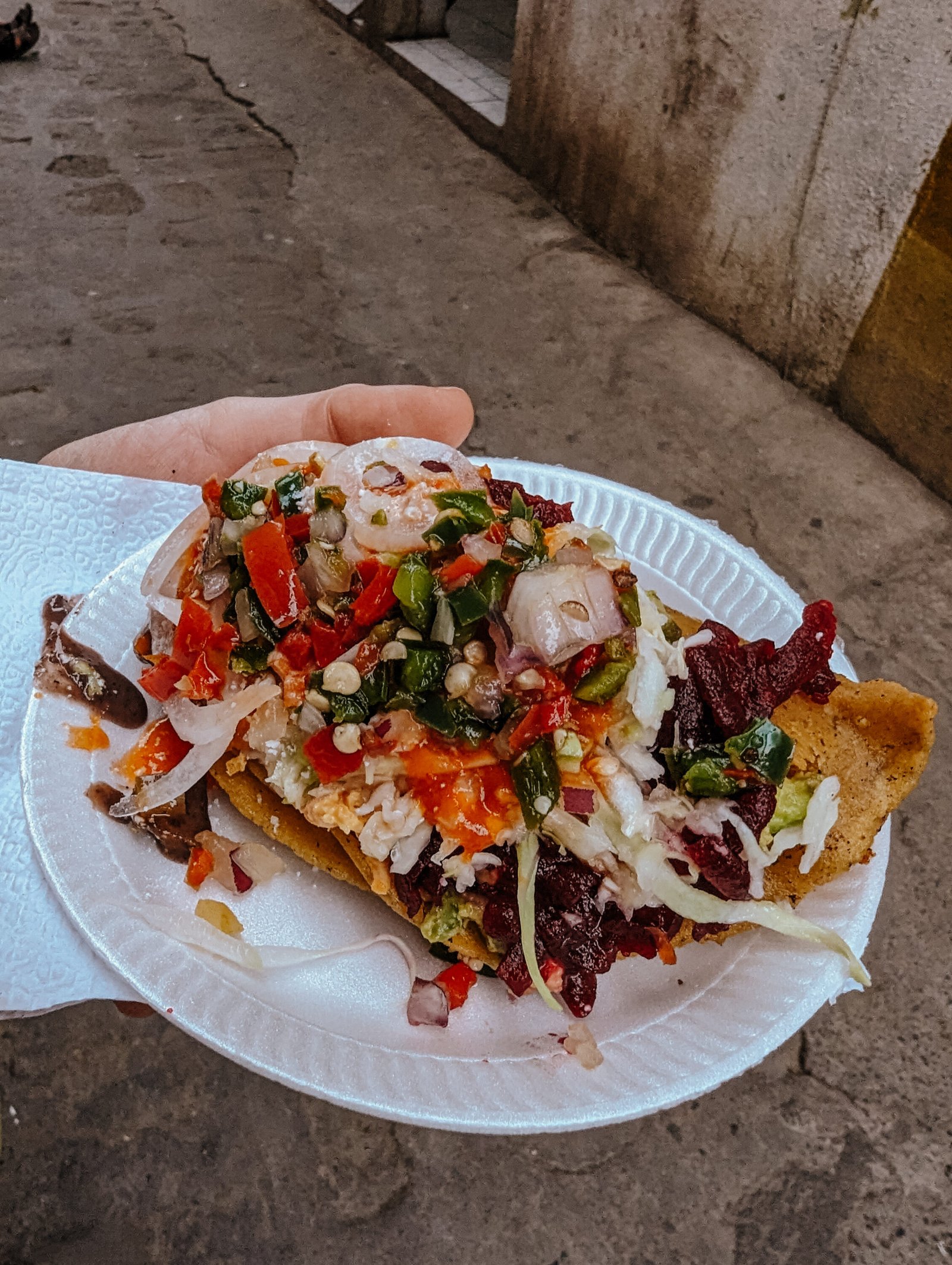Tostadas with a ton of tasty toppings from a street stall