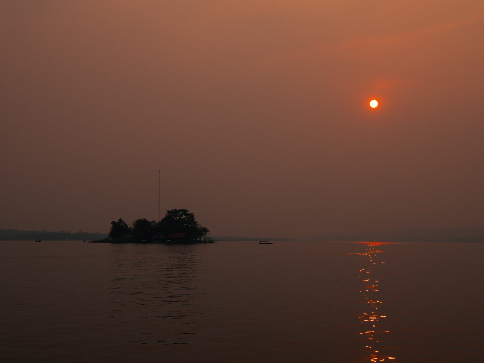 A very hazy sunset over Lago Petén Itzá