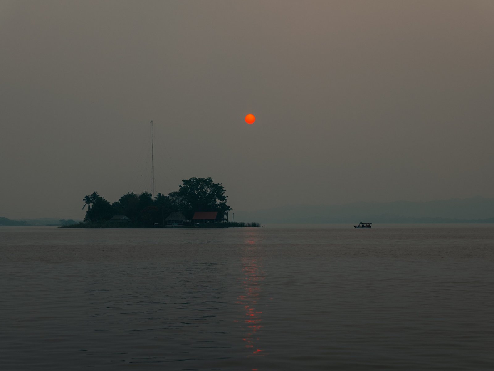 A very hazy sunset over Lago Petén Itzá