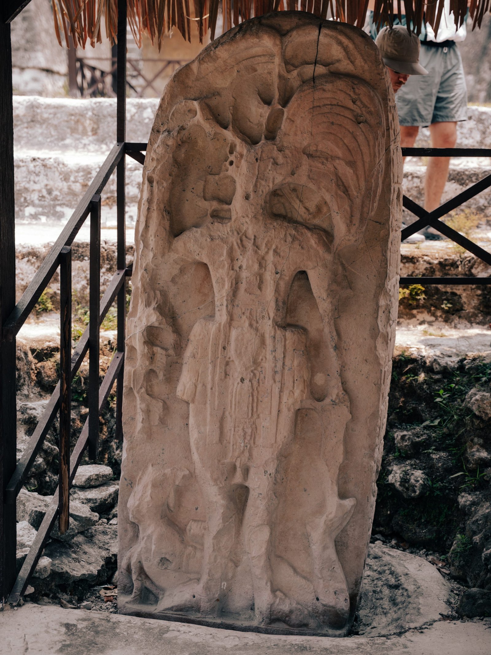 A figure carved into stone at the base of one of the temples